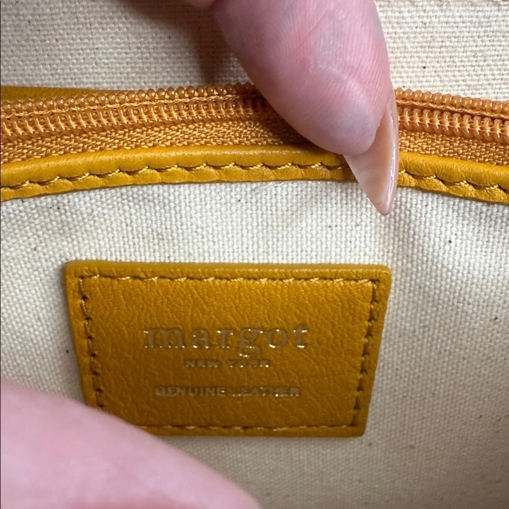 Margot Anna Zip Around Leather Wallet in marigold yellow.